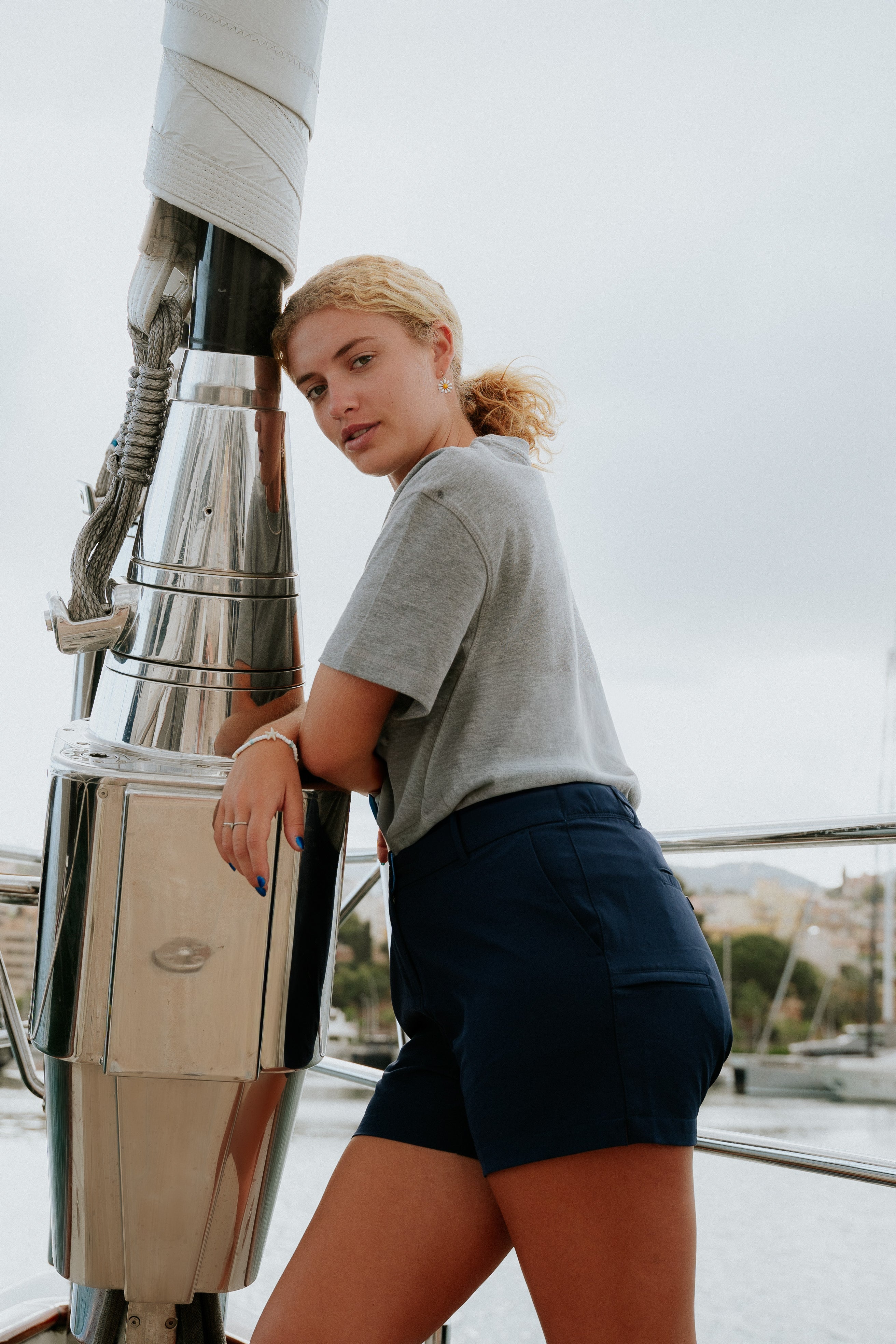 Women wearing navy chino deck shorts on a sailboat. Women's deck shorts. Yachtwear, workwear