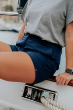 Women wearing navy chino deck shorts on a sailboat. Women's deck shorts. Yachtwear, workwear