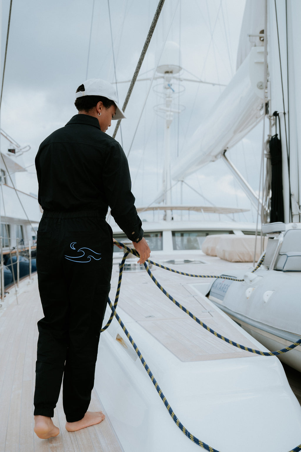 Woman in black boiler suit / coveralls. Workwear, streetwear. Workwear style