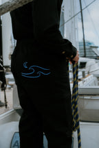 Woman in black boiler suit / coveralls. Workwear, streetwear. Workwear style