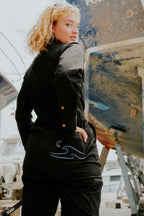 Woman in black boiler suit / coveralls. Workwear, streetwear. Workwear style