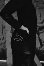 Woman in black boiler suit / coveralls. Workwear, streetwear. Workwear style