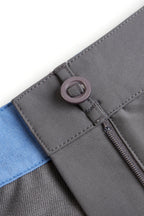 Close-up of a gray fabric with a zipper and blue trim on a white background. grey chino deck shorts. Women's deck shorts. Yachtwear, workwear