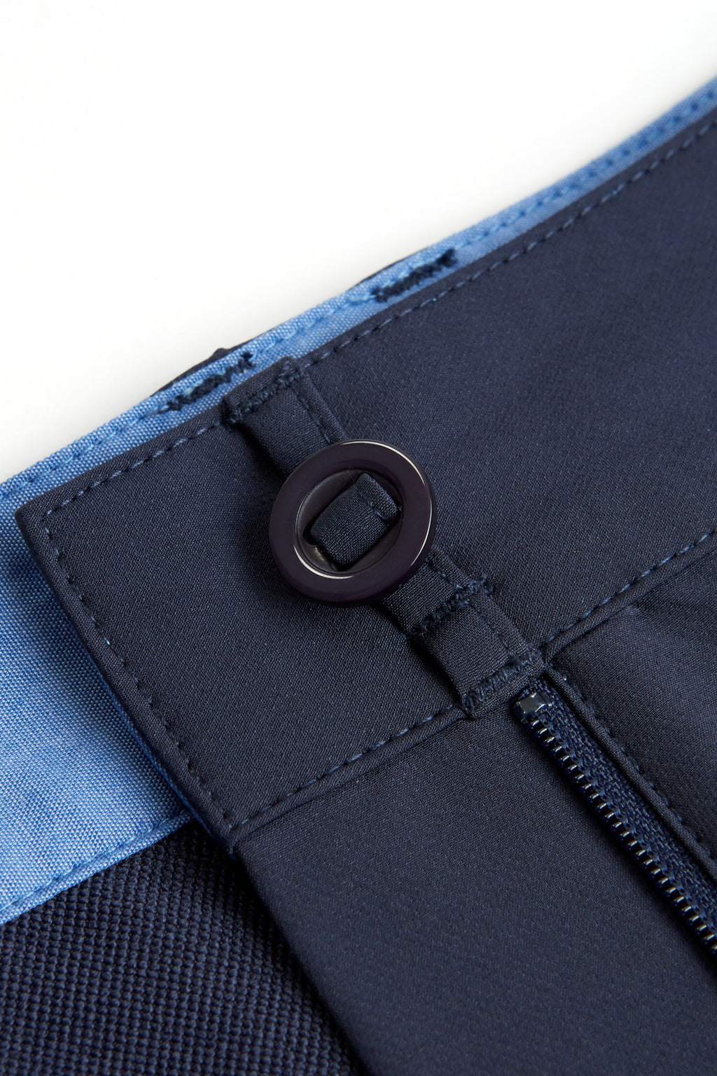 Close-up of a navy chino shorts with a button and zipper on a white background. Women's deck short. yachtwear, workwear