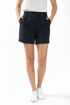 Person wearing navy chino deck shorts on a white background. Women's deck short. Yachtwear, workwear