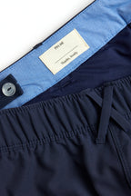 Navy shorts with white trim on a white background. Women's deck shorts. Yachtwear, workwear