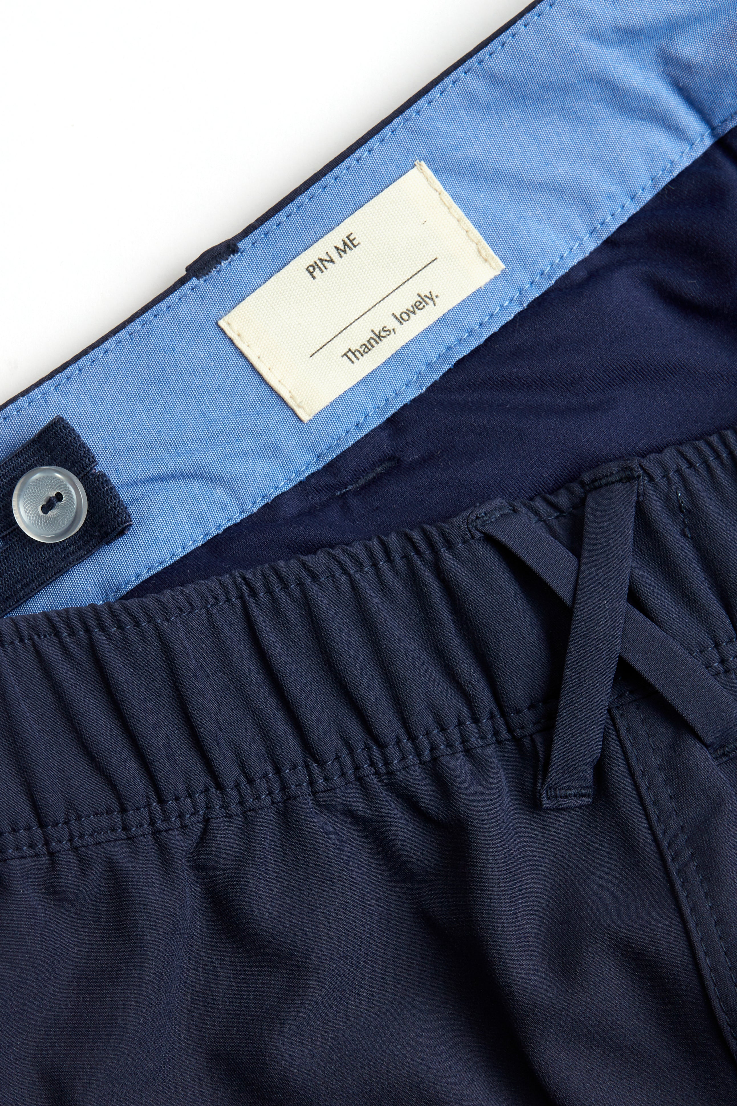 Navy shorts with white trim on a white background. Women's deck shorts. Yachtwear, workwear