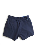 navy chino shorts on a white background. Women's deck shorts. Yachtwear, workwear