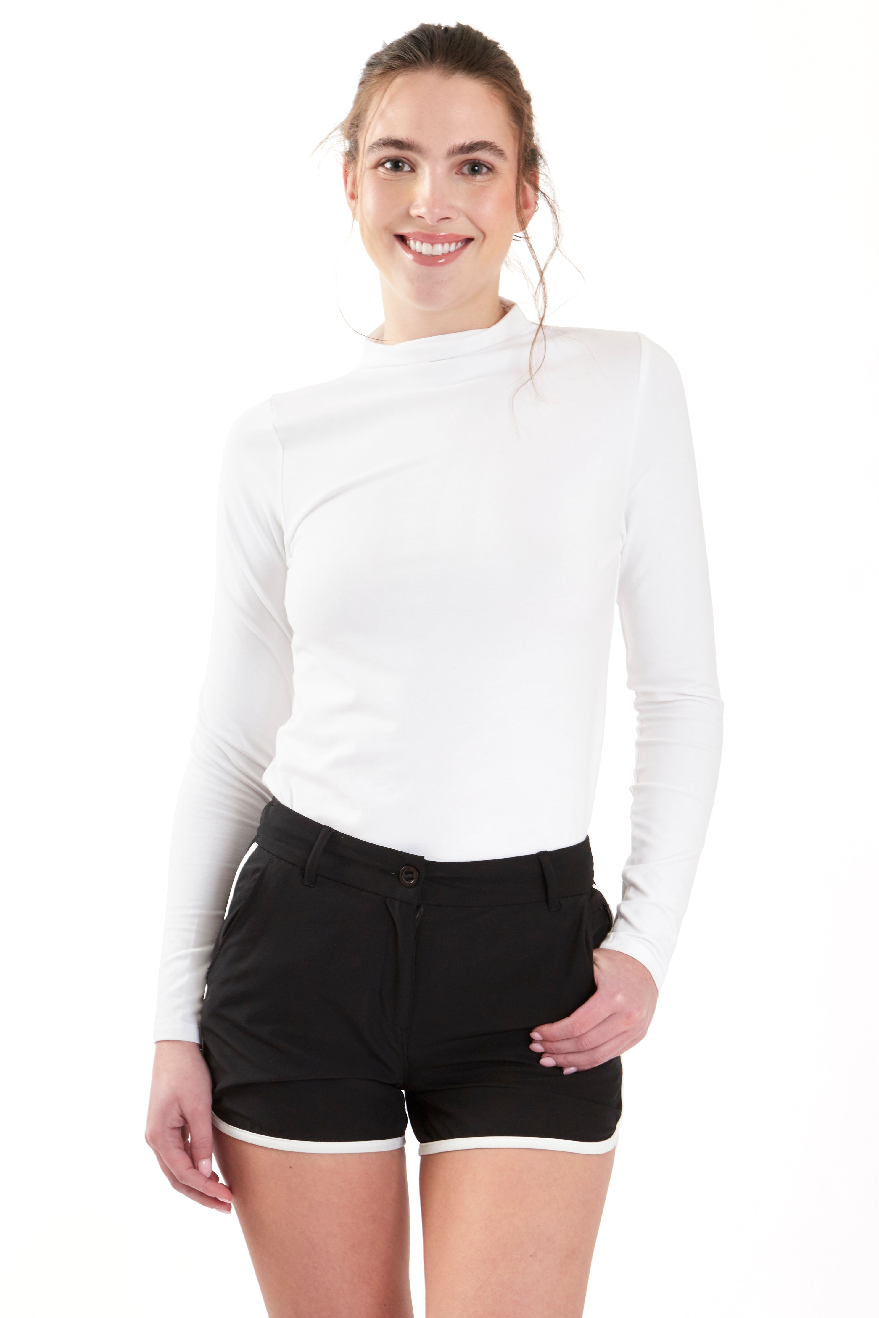 Woman wearing a white long-sleeve top and gray shorts on a white background. Women's deck shorts. Yachtwear, workwear