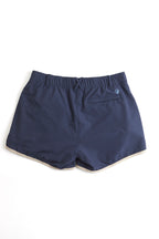 Navy shorts with white trim on a white background. Women's deck shorts. Yachtwear, workwear