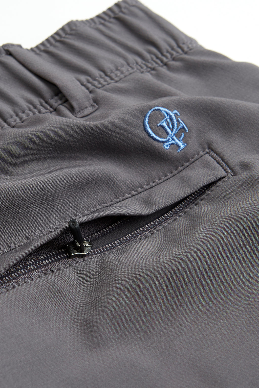 Woman wearing a white long-sleeve top and gray shorts on a white background. Women's deck shorts. Yachtwear, workwear