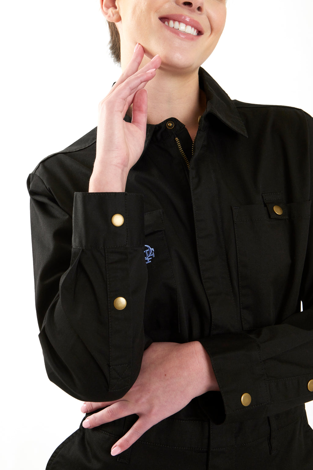 Woman in black boiler suit / coveralls. Workwear, streetwear. Workwear style
