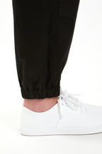 Woman in black boiler suit / coveralls. Workwear, streetwear. Workwear style