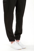 Woman in black boiler suit / coveralls. Workwear, streetwear. Workwear style