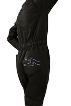 Woman in black boiler suit / coveralls. Workwear, streetwear. Workwear style