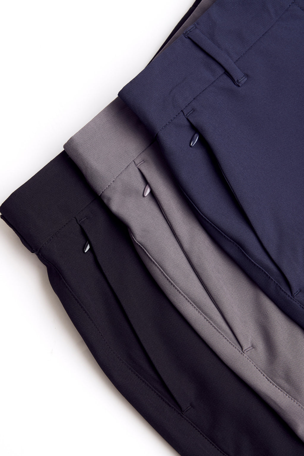 Three pairs of chino deck shorts in black, gray, and navy on a white background. Women's deck shorts. Yachtwear, workwear. WOmen's deck shorts