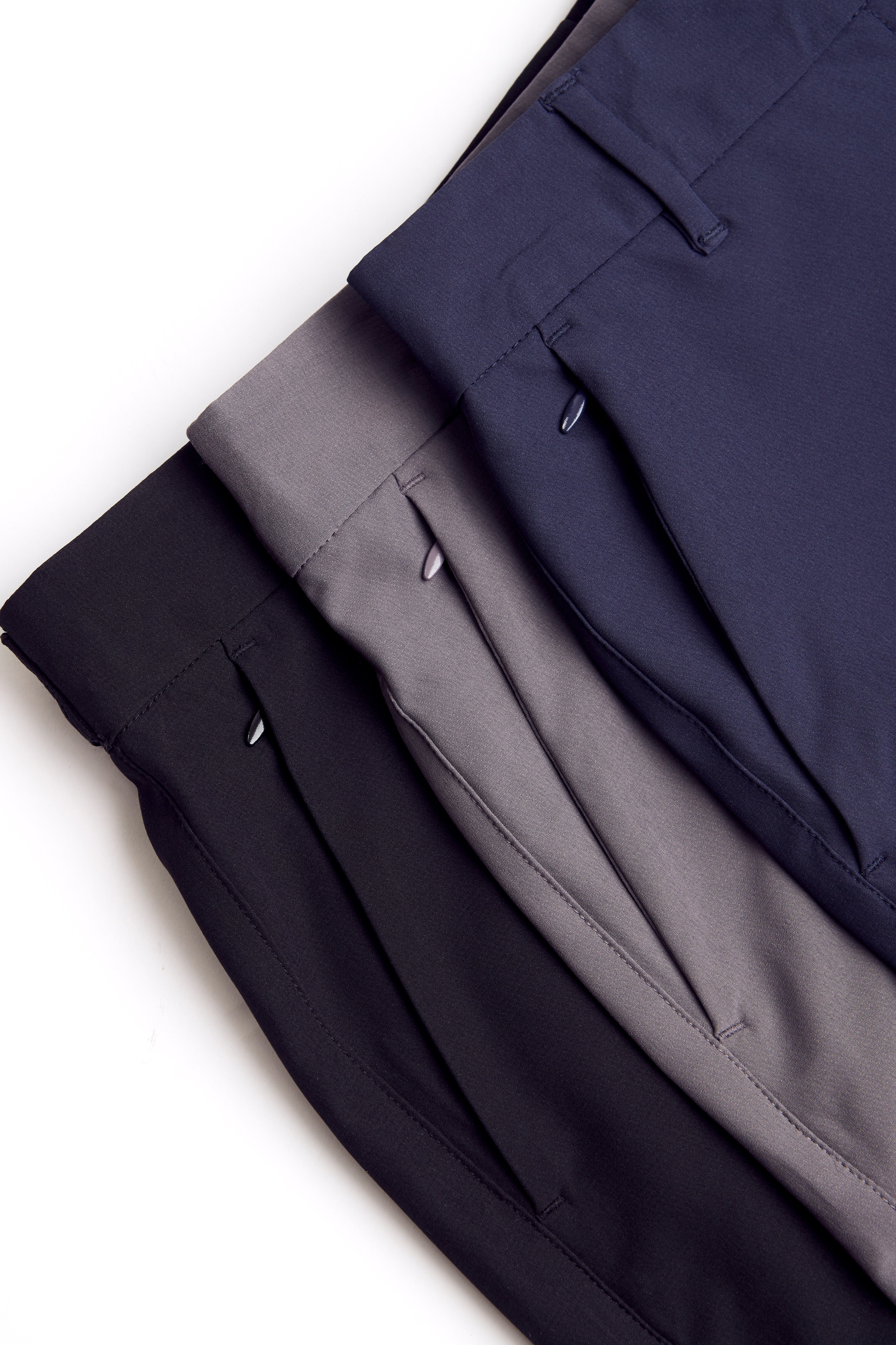 Three pairs of chino deck shorts in black, gray, and navy on a white background. Women's deck shorts. Yachtwear, workwear. WOmen's deck shorts