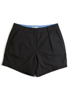 Black chino shorts on a white background. Yachtwear. Women's deck shorts.