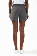 Person wearing gray chino shorts on a white background. Yachtwear. Women's deck shorts. 